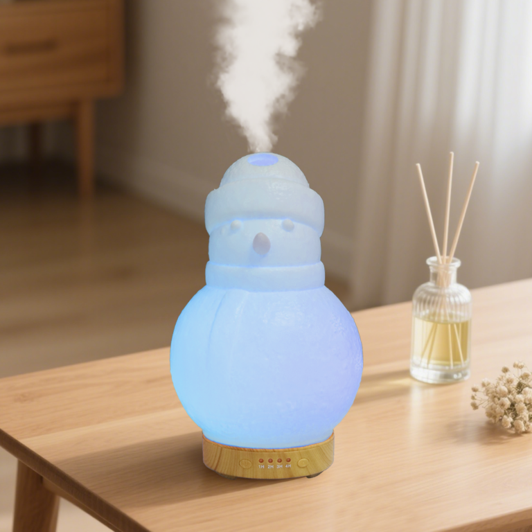 WP-176 snowman mini essential oil diffuser in frosted white with blue ambient light on a sideboard