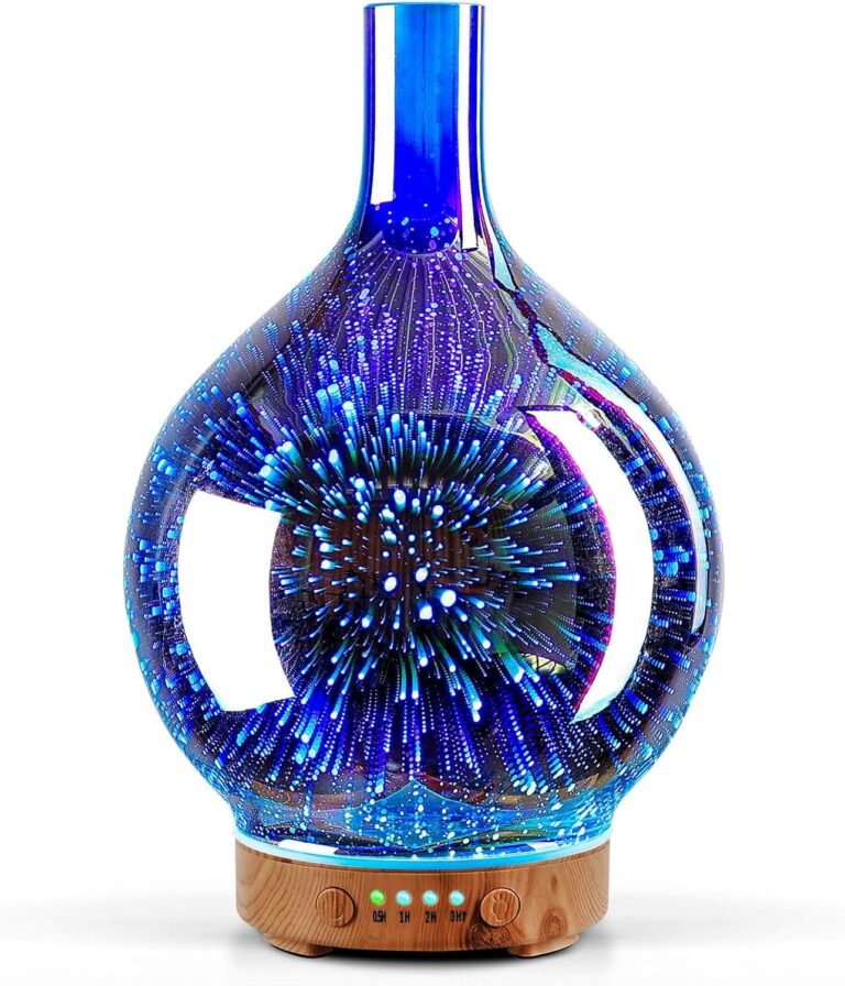Handmade art glass aroma diffuser with a deep blue ring pattern on a wood grain base