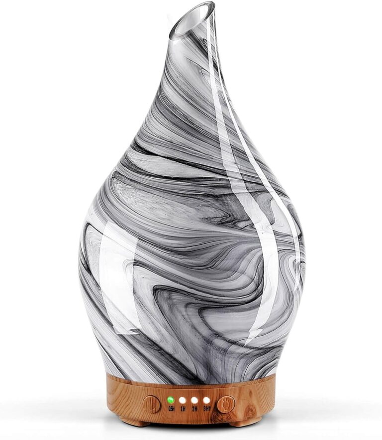Handmade art glass aroma diffuser with a black and white ink marble pattern on a wood grain base