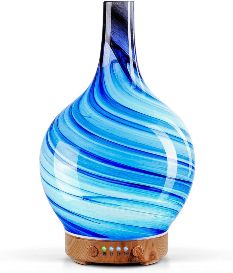 Handmade art glass aroma diffuser with an ocean wave pattern on a wood grain base