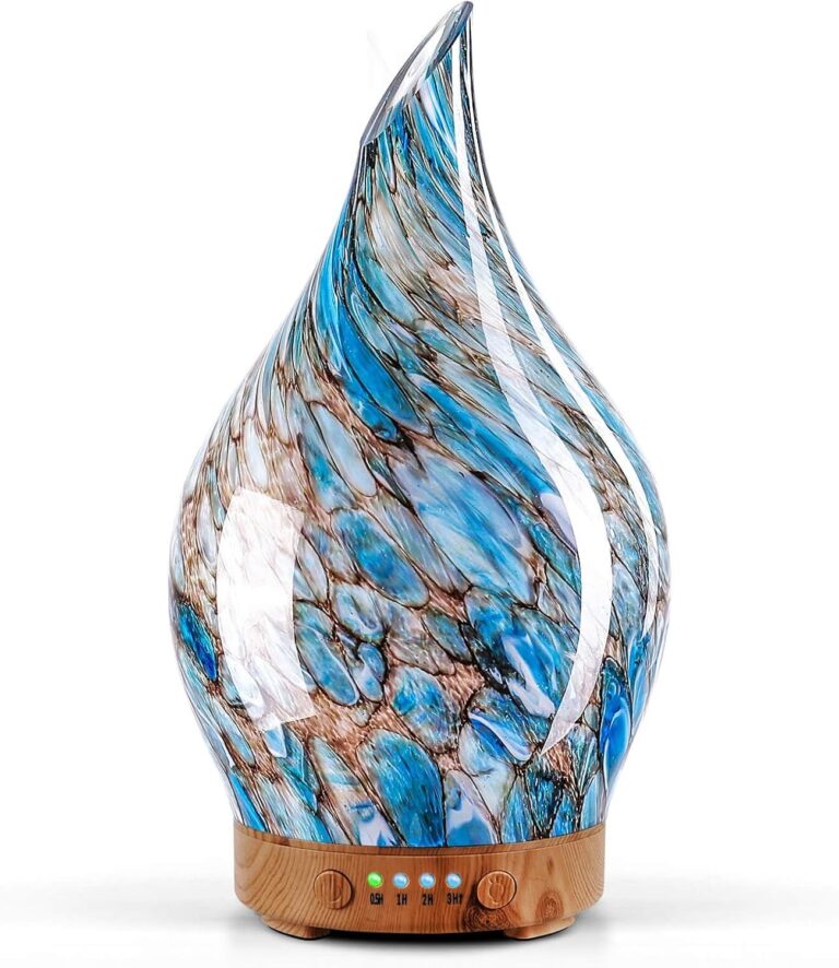 Handmade art glass aroma diffuser with a blue and brown sea pebble pattern on a wood grain base