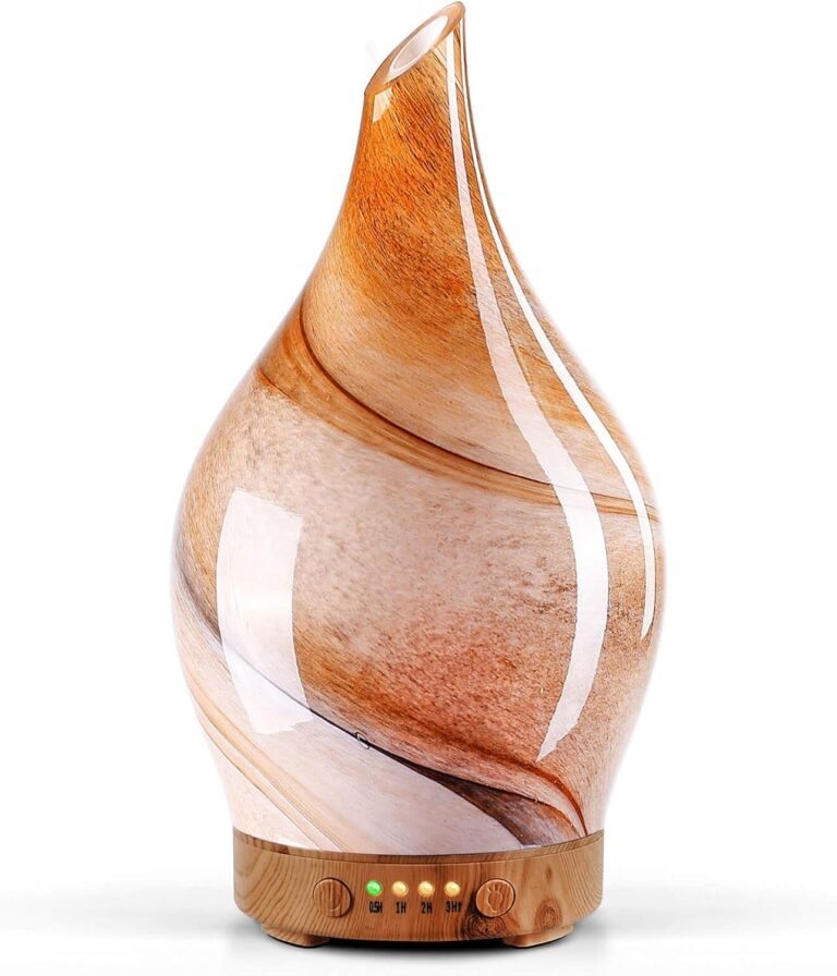 Handmade art glass aroma diffuser with a brown wood grain swirl pattern on a wood grain base